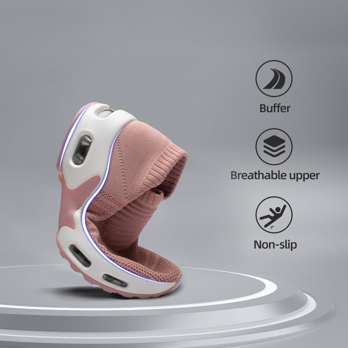 Pink children's shoe with white sole on a gray background, featuring icons for buffer, breathable upper, and non-slip.