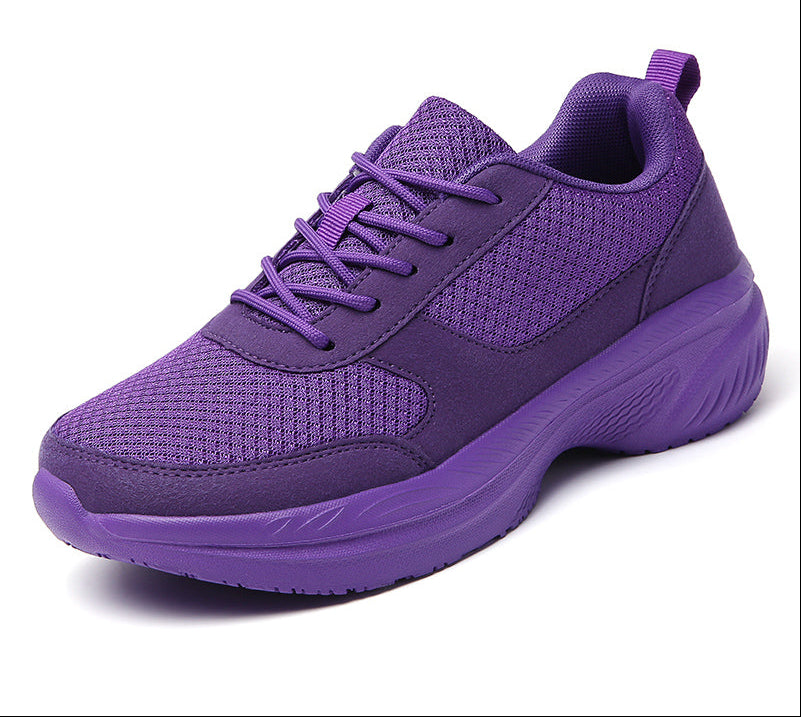 A pair of stylish purple women's sports shoes with a breathable mesh upper and a chunky sole, suitable for casual wear or light exercise.